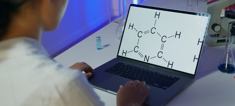 a scientists looking at chemical formula on laptop while doing peptide terminology research