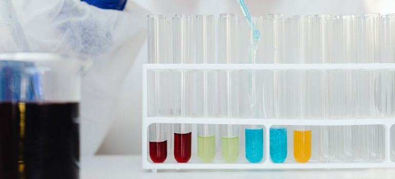 a researcher carefully pipetting liquid samples into labeled test tubes