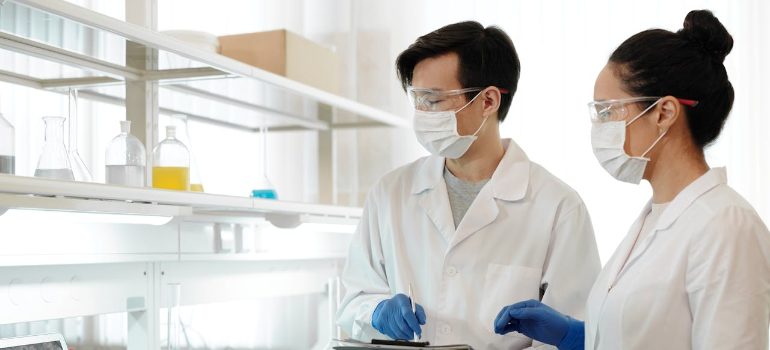 two lab technicians are comparing BPC-157 vs TB-500 in a lab