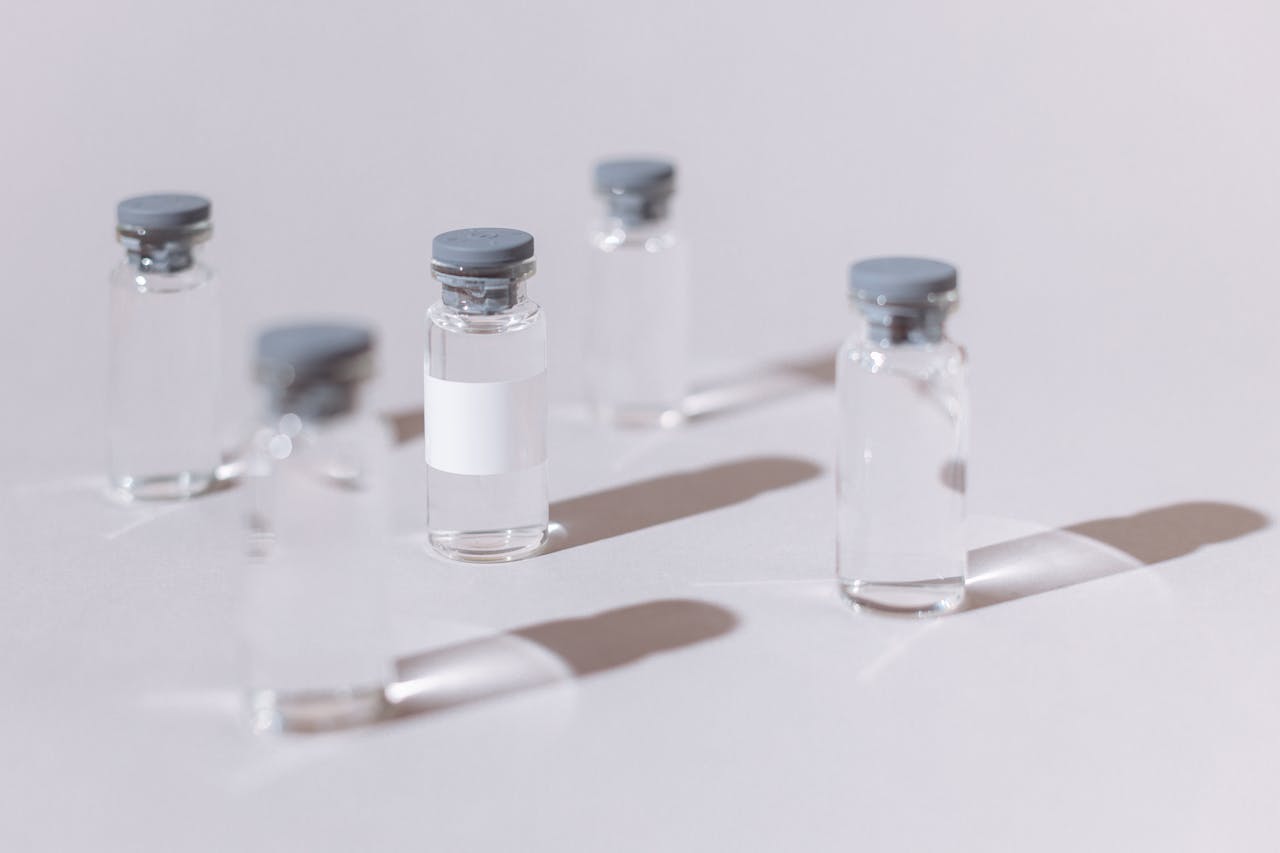 clear glass vials displayed on a sterile white surface