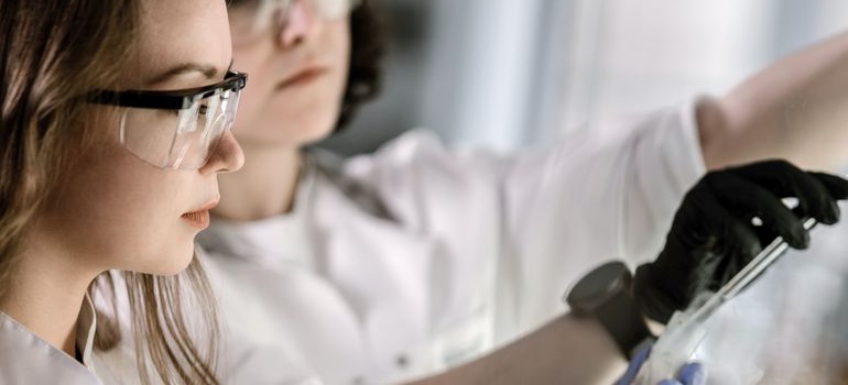 Researchers comparing GHRH vs Ghrelin while handling laboratory equipment during an experiment