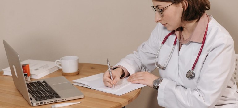 a researcher sitting and taking notes on specialty research peptides
