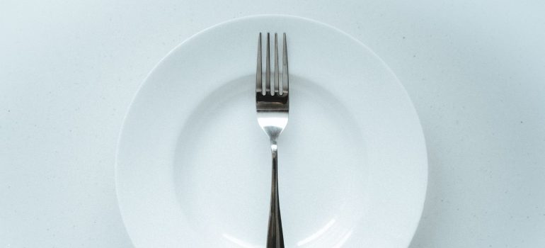 a minimalist setup with a fork centered on a white plate