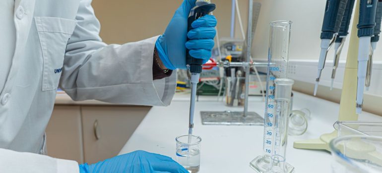Lab scientist using pipette in chemical experiment with precision