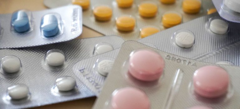 Close-up view of assorted colorful medication blister packs with diverse pills